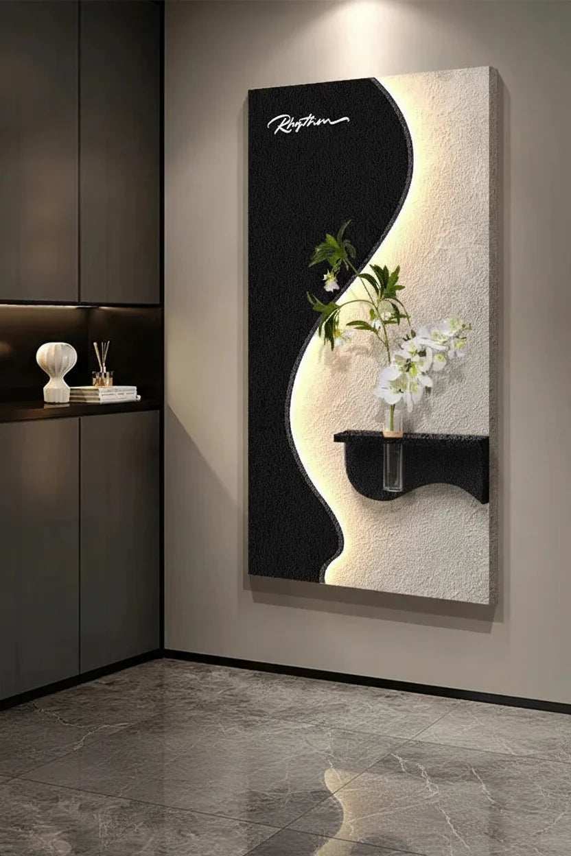 Green Plant LED Wall Lamp with black and cream sculptural panels, a curved illuminated edge, and an ornamental green plant with white flowers