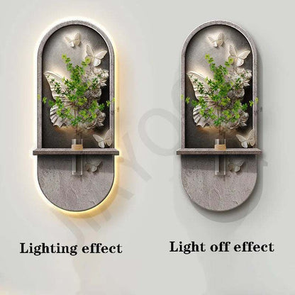 Green Plant Wall Lamp with a gray stone-look arched panel, raised green foliage, butterfly accents, and a slim shelf