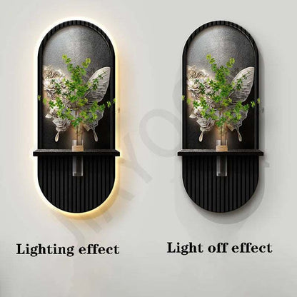 Green Plant Wall Lamp with black ribbed oval frame, arched botanical relief and warm halo glow around the edge