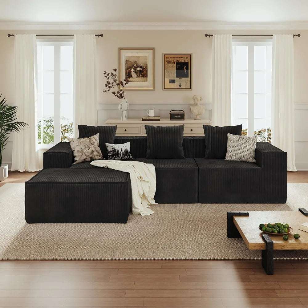 L Shaped Sectional Sofa in black ribbed corduroy with a chaise lounge and assorted neutral throw pillows