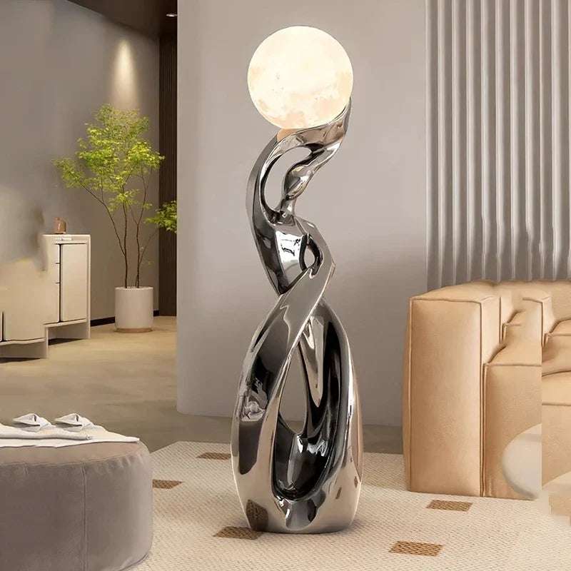 LED Floor Lamp Alloy Stand Light with a polished silver alloy stand, sculptural twisted design, and glowing spherical shade