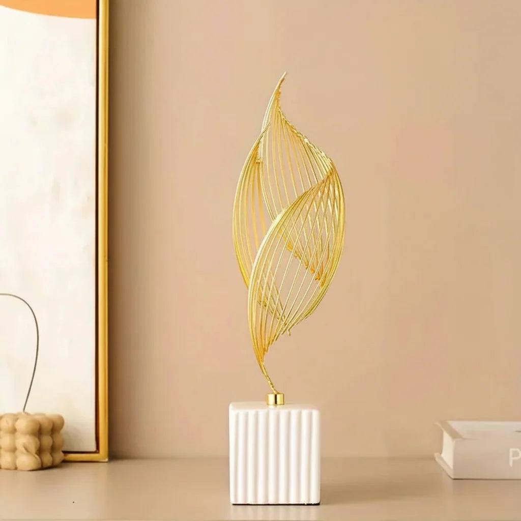 Nordic Ceramic Statue with a white ribbed ceramic base and slender gold metal wire sculpture in an abstract leaf shape.