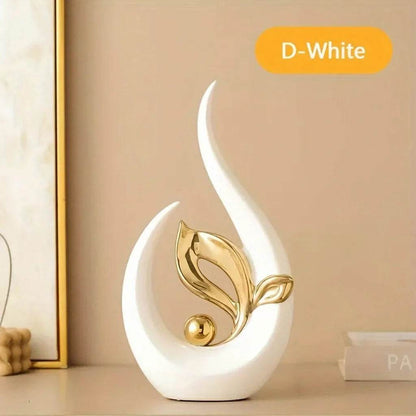 Nordic Ceramic Statue in glossy white ceramic, shaped like a curved flame with a gold metallic leaf and orb accent.