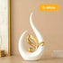 Nordic Ceramic Statue in glossy white ceramic, shaped like a curved flame with a gold metallic leaf and orb accent.
