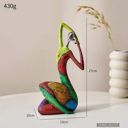 Nordic Style Abstract resin figurine with a seated, elongated figure in textured green, red, blue and gold geometric colors.