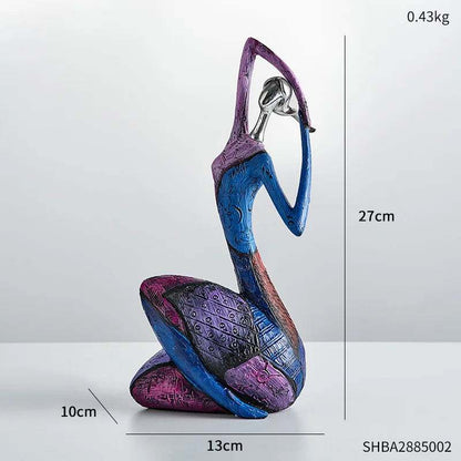 Abstract resin figurine in blue, purple and magenta with geometric patterns, showing a seated figure with raised arms; Nordic Style Abstract is 27 cm tall.