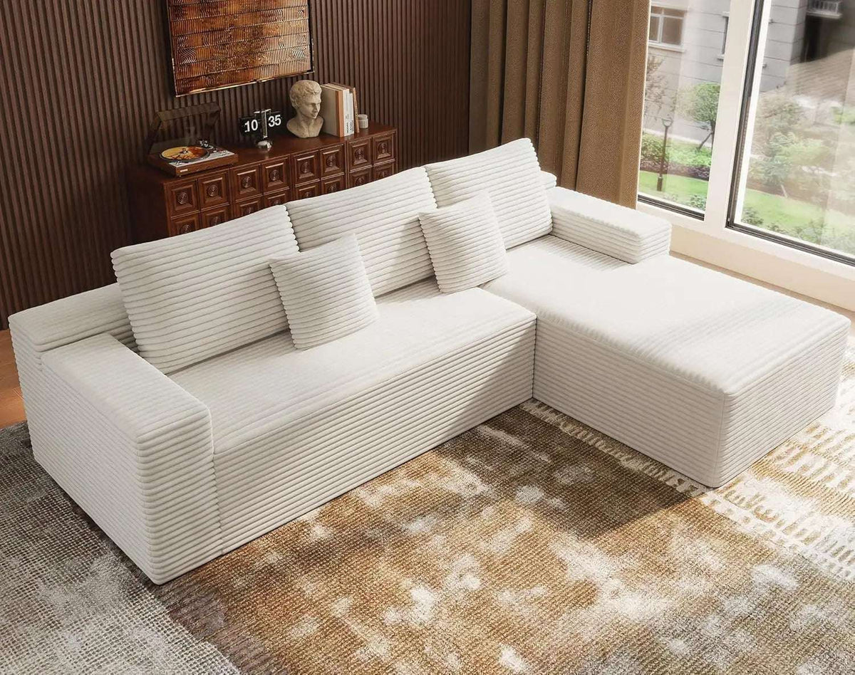 Oversized Deep Seat L-shaped modular sofa in white ribbed corduroy, with a chaise, broad cushions and matching pillows.