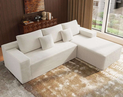 Oversized Deep Seat L-shaped modular sofa in white ribbed corduroy, with a chaise, broad cushions and matching pillows.
