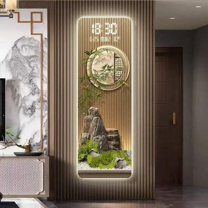Perpetual Calendar Pendant Clock wall light with a gold-toned slatted panel, illuminated digital display, round clock and miniature landscape feature.