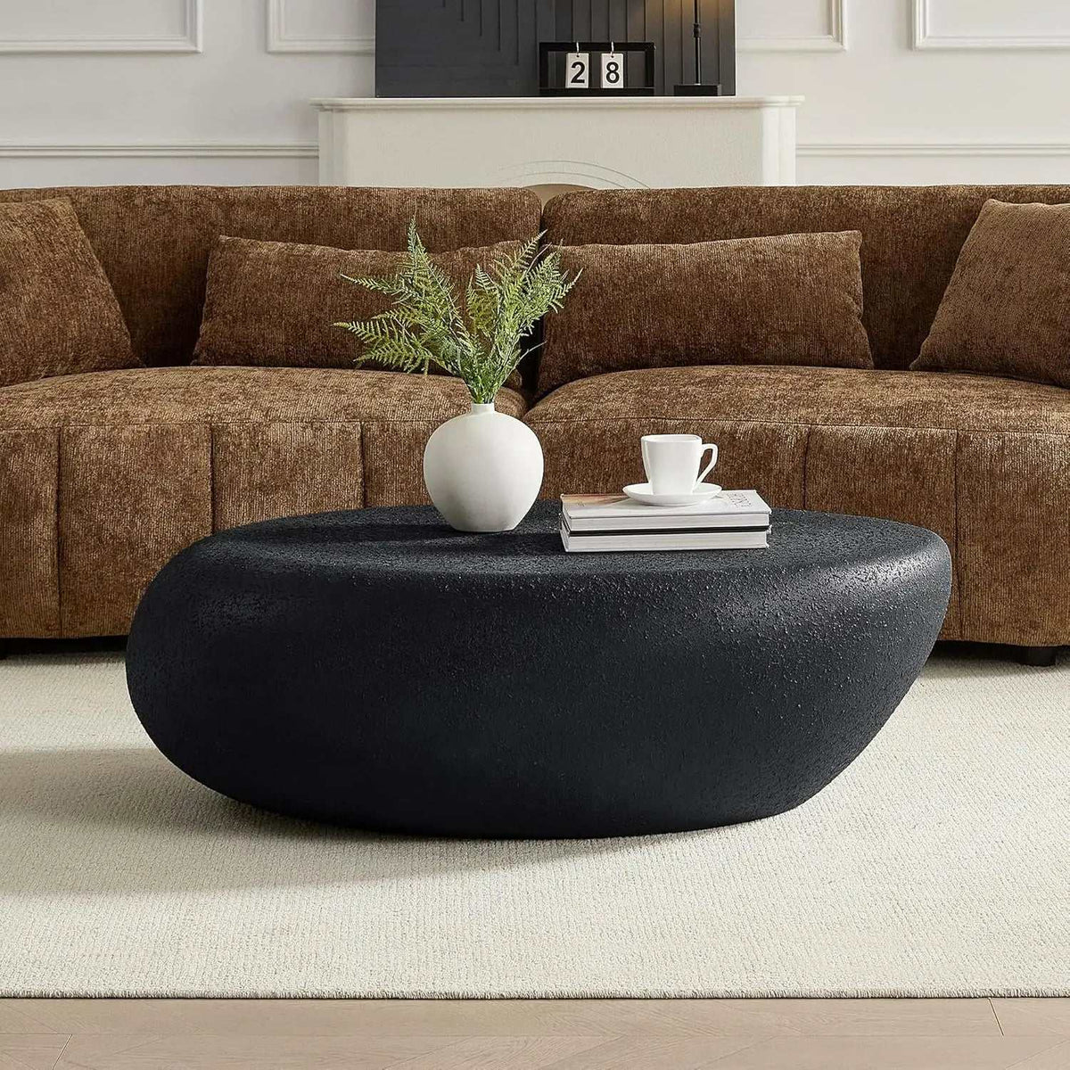 Stone Coffee Table Fiberglass Frame in charcoal black faux stone, with a textured finish and low oval sculptural form.